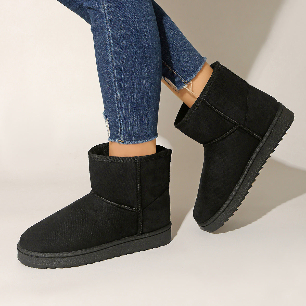 Black pull-on ankle boots with round toe, suede-look upper and flat rubber sole