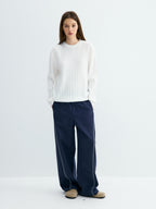 White ribbed crew neck sweater with wide rib knit and relaxed banded cuffs