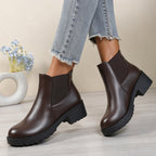 Women’s chunky Chelsea boots in dark brown, side view with elastic panels and lug sole.