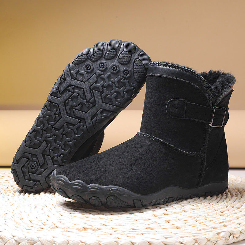 Women's winter boots in black, buckle strap, faux fur collar, rugged textured tread sole.