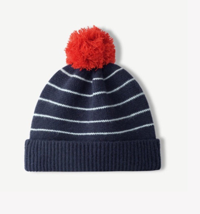 Navy striped knit beanie with fluffy red pom-pom and ribbed cuff