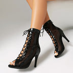 Black peep-toe lace-up stiletto ankle booties with open toe and sheer panels.