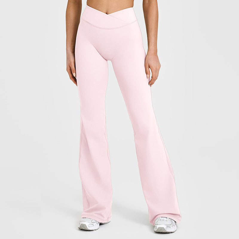 Women’s high-waisted crossover flare leggings in blush pink, wide bootcut pant legs