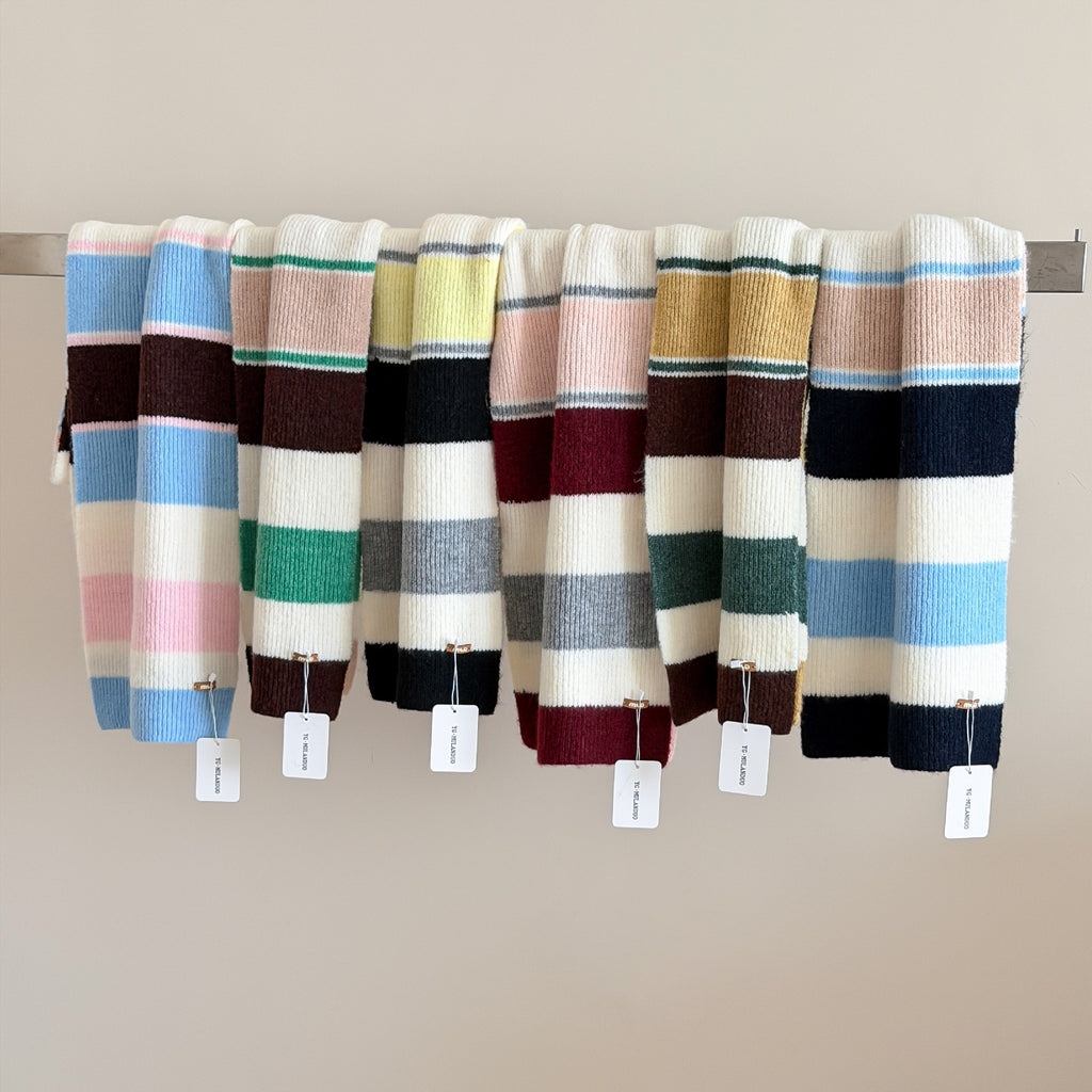 Women’s striped wool scarves, wide knit stripes in assorted blue, cream, pink, and maroon.