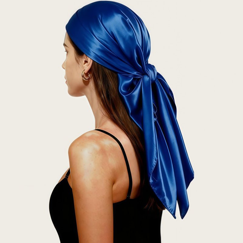 Satin head scarf in royal blue, tied back with long flowing tails.