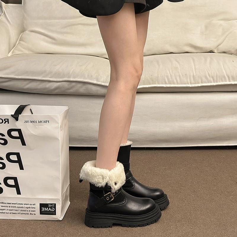 Black platform winter boots with faux-fur fold-over cuff and double buckle strap details