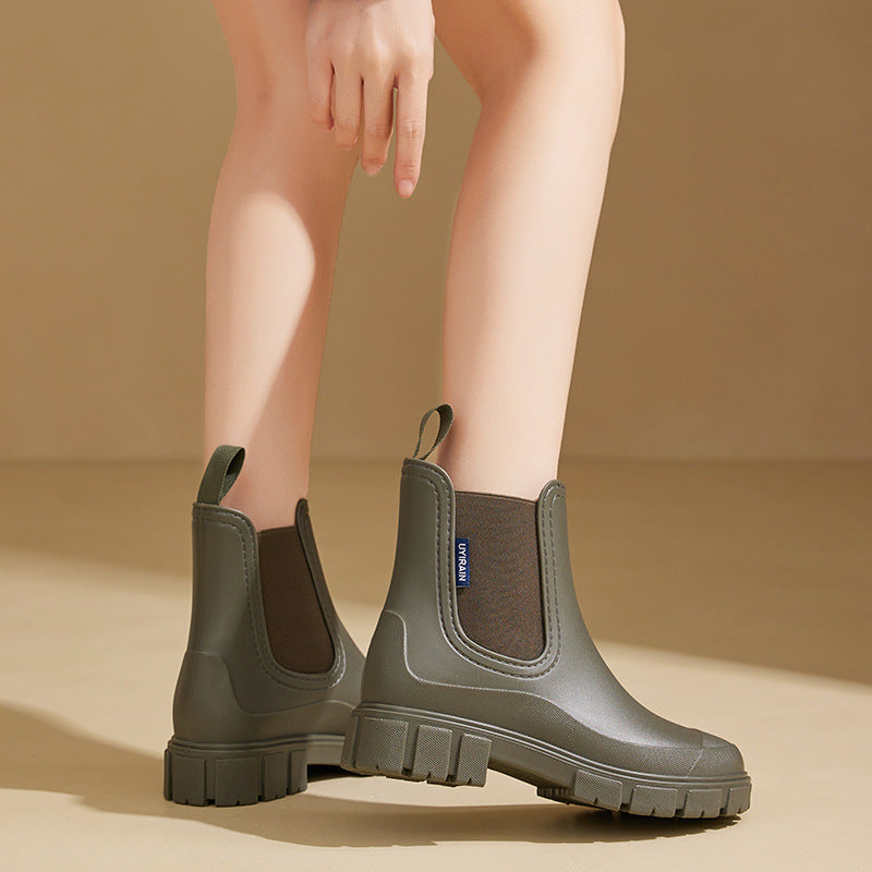 Chelsea rain boots in olive green matte rubber with chunky lug sole and pull tab.