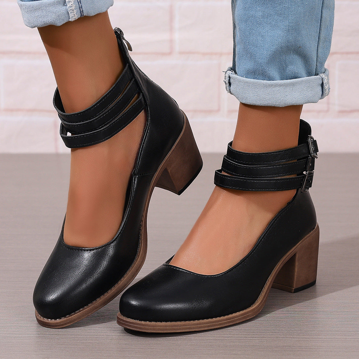 Black closed-toe block heel pumps with ankle strap and side buckle