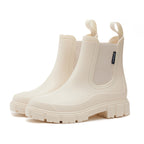 Chelsea rain boots in light cream matte rubber with side elastic panels and lug sole.