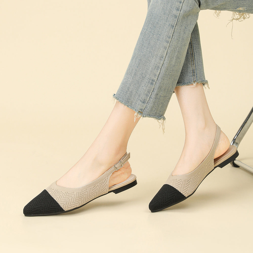 Woven pointed-toe slingback flats with thick sole, beige with black toe, on feet