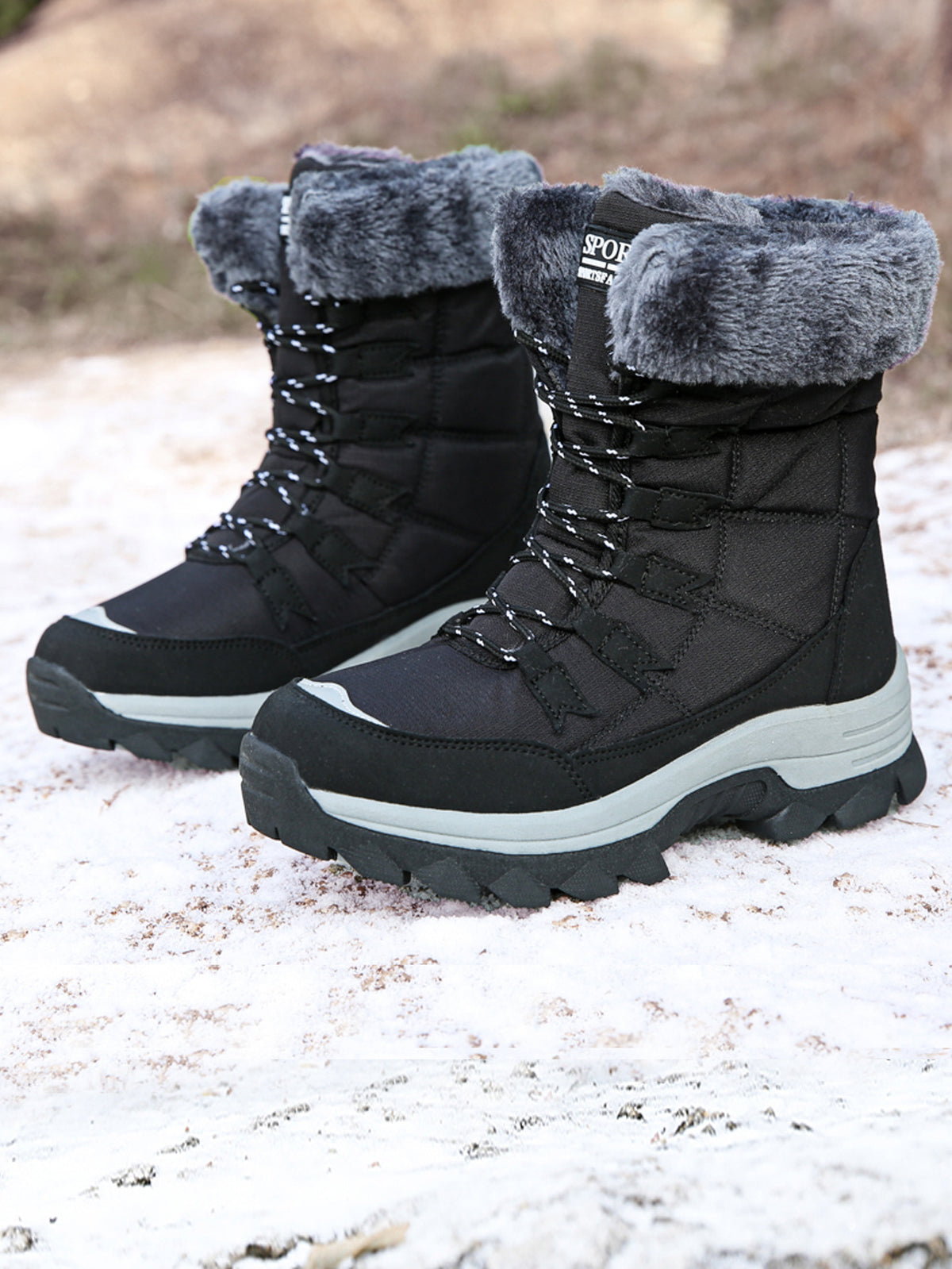 Black mid-calf snow boots with gray faux-fur cuff, lace-up straps, and thick sole