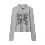 Light gray long-sleeve zip-up top with stand collar and distressed graphic front
