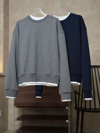 Waffle-knit crewneck sweatshirts in gray and navy, both with ribbed cuffs