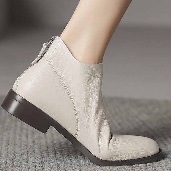 Off-white leather ankle boots with low block heel and back zip, side view