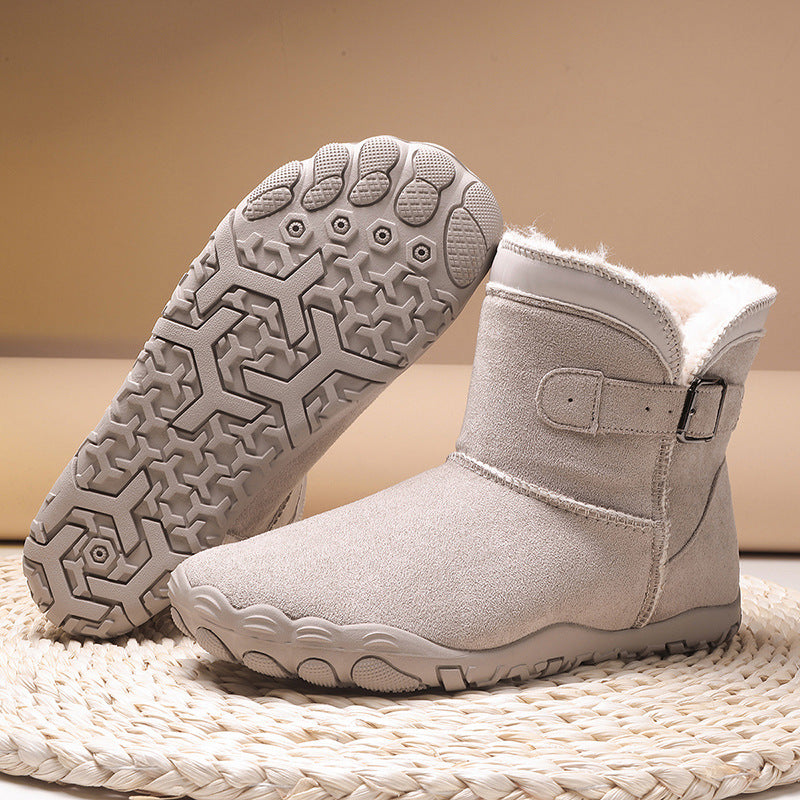 Women's winter boots in light gray, buckle strap, faux fur trim, textured non-slip tread.