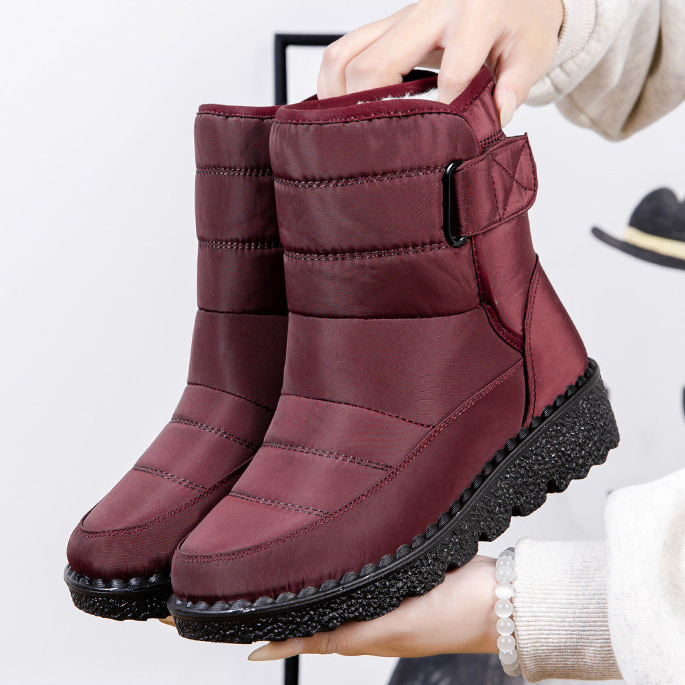 Wine red quilted platform puffer snow boots with padded collar and adjustable side strap.