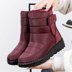 Wine red quilted platform puffer snow boots with padded collar and adjustable side strap.