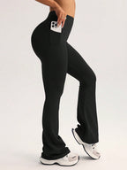 Black high-waist flare leggings with front pocket, hand holding phone