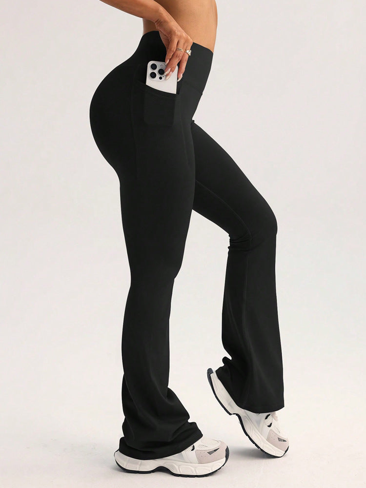 Black high-waist flare leggings with front pocket, hand holding phone