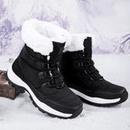 Women’s black faux fur lined lace-up high top snow boots with chunky lug sole.