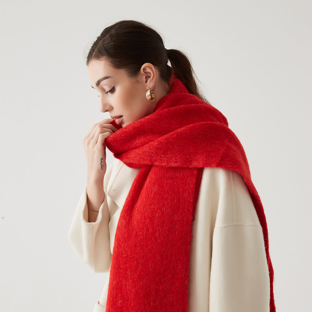 Oversized fuzzy mohair-blend scarf with fringe ends, vivid red, worn draped over shoulders