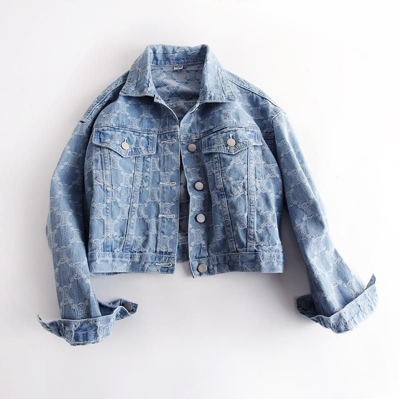 Blue paisley-print denim trucker jacket with button front, chest pockets, and long sleeves