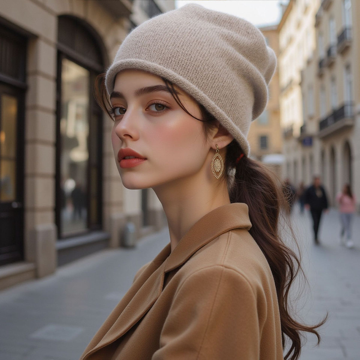 Women’s knitted beanie hat in beige, folded cuff and soft knit texture.