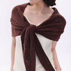 Dark brown triangle scarf worn as a shoulder wrap, tied at the front with long ends.