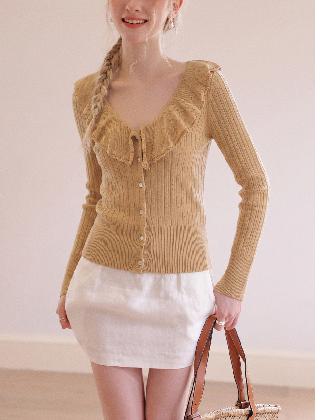 Tan knit cardigan with ruffle V-neck collar, button front, long sleeves