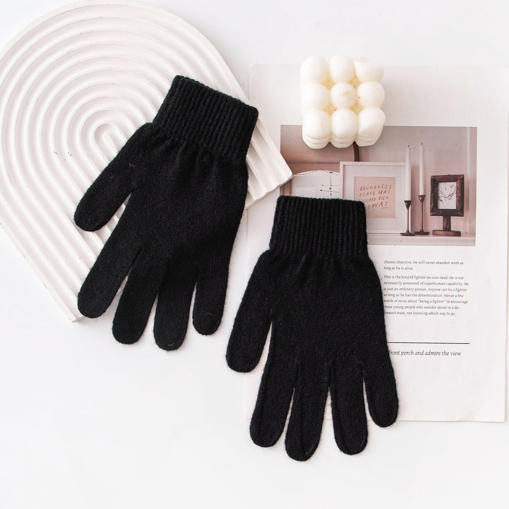 Black knit winter gloves with ribbed cuffs and five-finger design