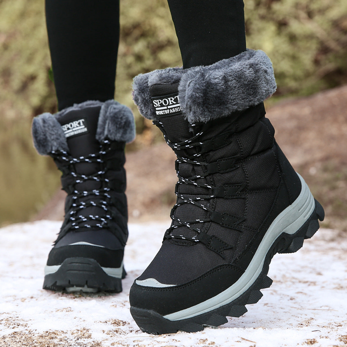 Black mid-calf snow boots with gray faux-fur cuff, lace-up front, and thick lug sole