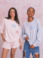 Pink oversized crewneck sweatshirt with floral American flag graphic, soft fleece