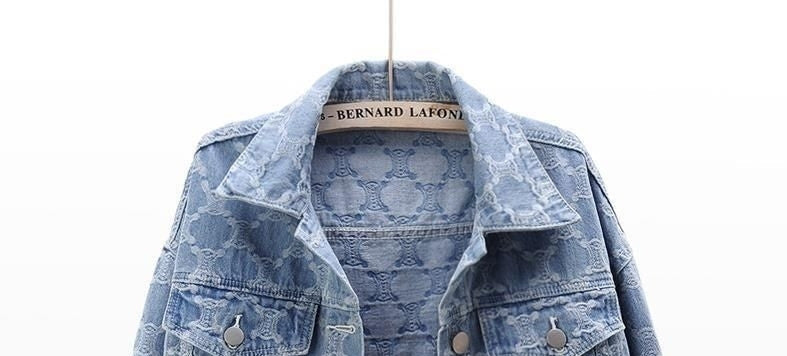 Upper view of blue paisley-print denim jacket with button front and chest pockets