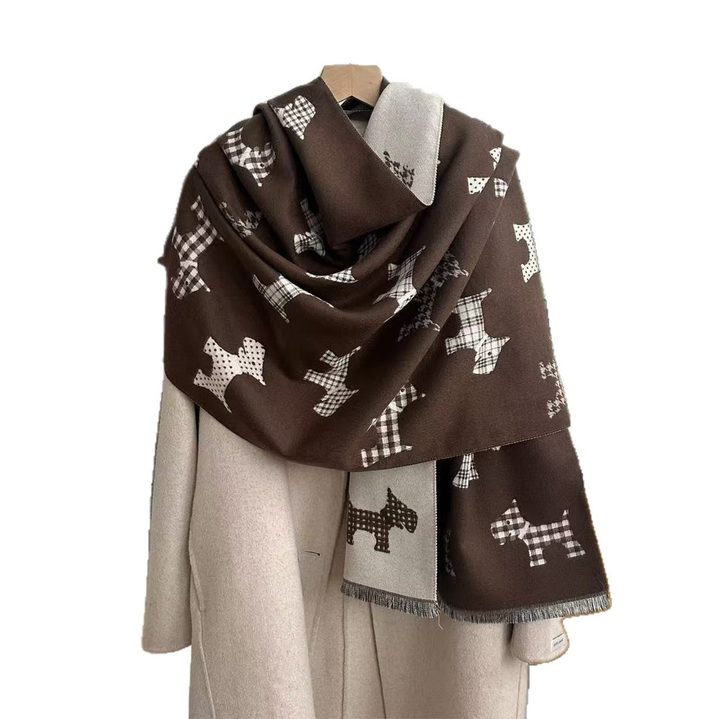 Dark brown dog-print blanket scarf with a light reverse and fringed ends, draped over a coat
