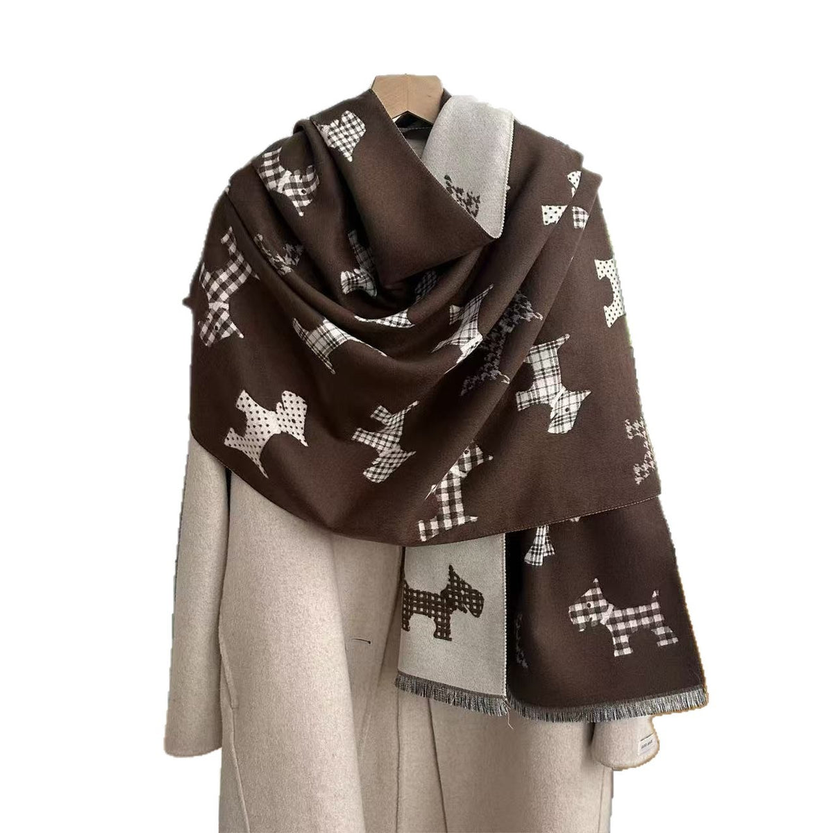 Dark brown dog-print blanket scarf with a light reverse and fringed ends, draped over a coat