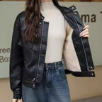 Black cropped faux leather jacket with snap placket, flap pockets, and light lining