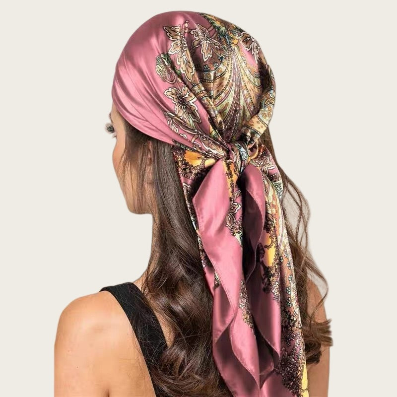 Large satin square scarf in pink with dark paisley and chain print, tied head wrap