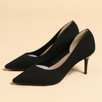Pair of women's pointed-toe knit stiletto pumps, black, 3/4 side view
