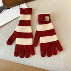 Women’s striped knit gloves in red and cream with long ribbed cuffs and five-finger design