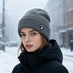 Gray ribbed knit beanie with fleece lining and logo patch