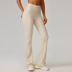 Beige high-waisted flare yoga leggings with tapered-to-bootcut leg shape.