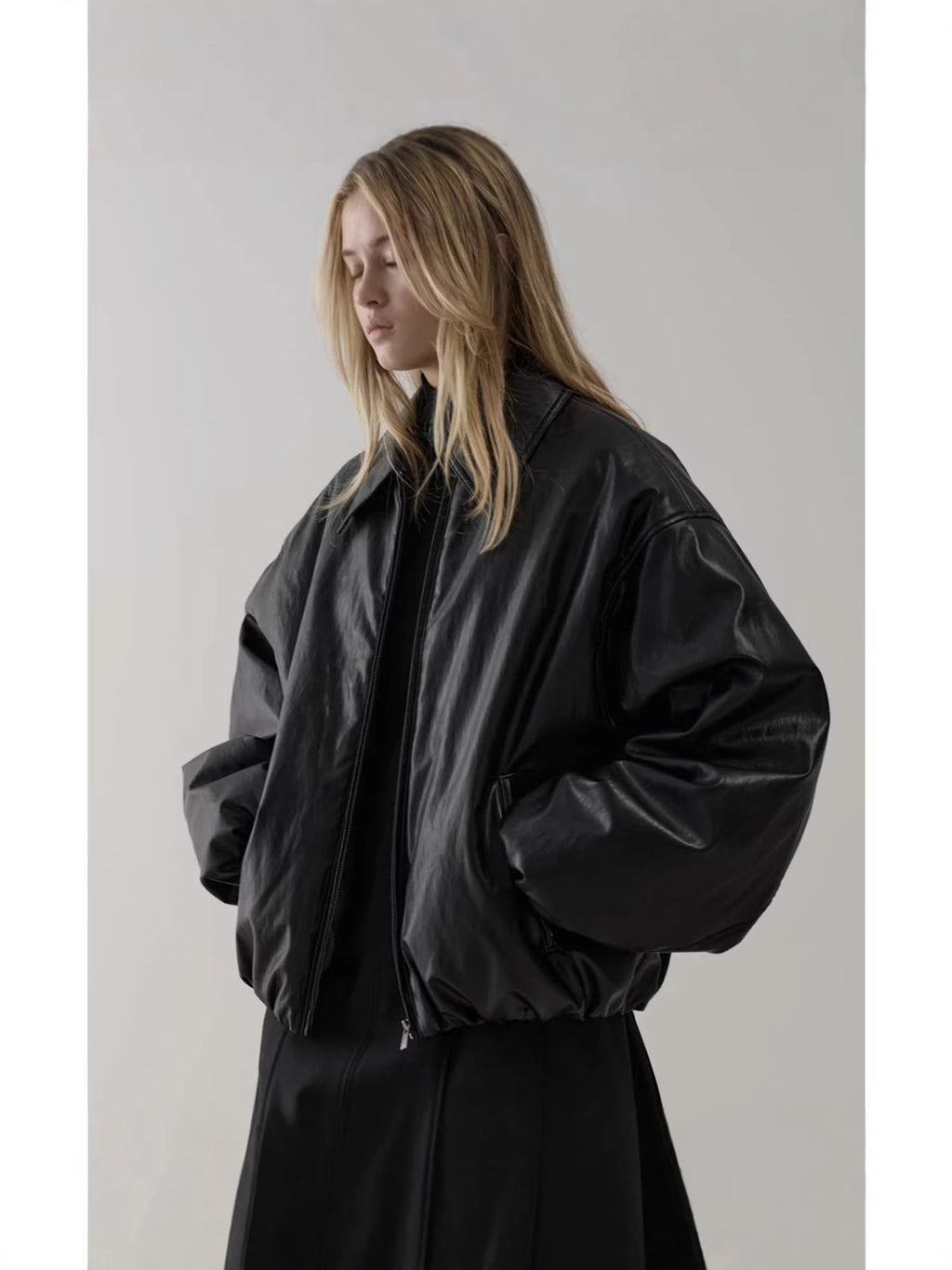 Black bomber jacket with oversized balloon sleeves and zip front, relaxed fit