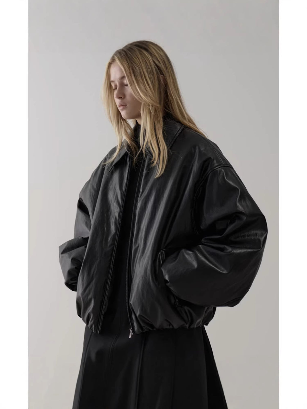Black bomber jacket with oversized balloon sleeves and zip front, relaxed fit