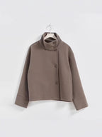 Cropped stand-collar wool jacket in taupe with button front and long sleeves on hanger