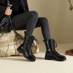 Black lace-up snow combat boots with quilted shaft and chunky lug sole