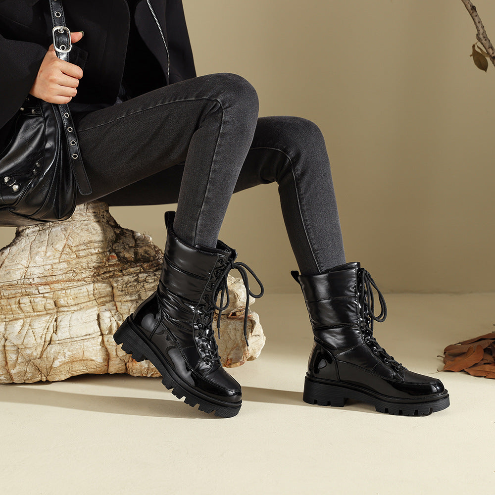 Black lace-up snow combat boots with quilted shaft and chunky lug sole