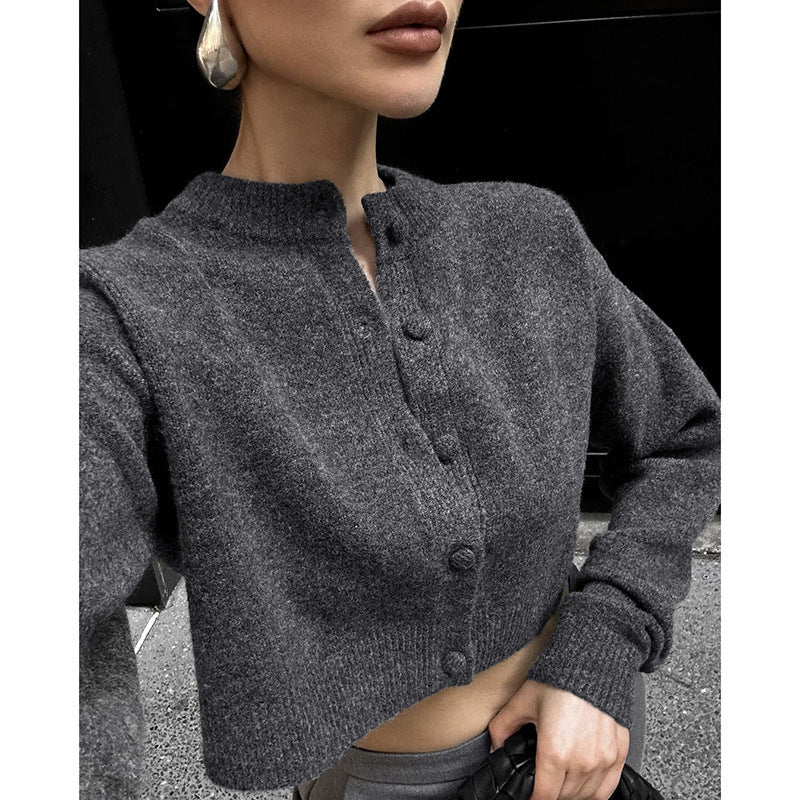 Dark gray wool cardigan close-up, button placket and ribbed cuff trim