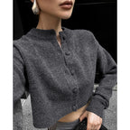 Dark gray wool cardigan close-up, button placket and ribbed cuff trim