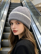 Ribbed knit beanie in gray with white contrast stitch stripe at the cuff.