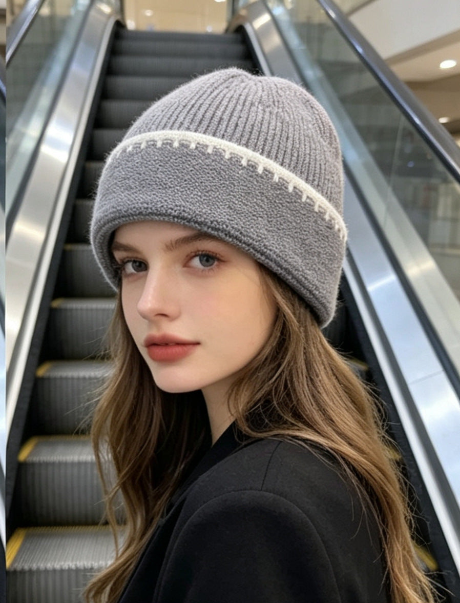 Ribbed knit beanie in gray with white contrast stitch stripe at the cuff.